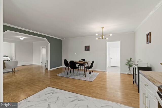 106 1st Ave, Lincoln University, PA 19352 - dining area with crown molding, a chandelier, arched walkways, light wood-style flooring, and baseboards
