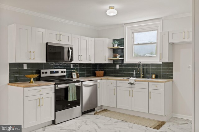 106 1st Ave, Lincoln University, PA 19352 - kitchen with appliances with stainless steel finishes, light marble finish flooring, white cabinets, a sink, and decorative backsplash