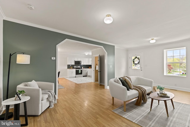 106 1st Ave, Lincoln University, PA 19352 - living area with ornamental molding, light wood-style floors, arched walkways, and baseboards