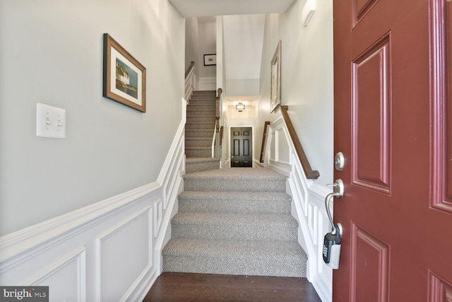 23492 Bluemont Chapel Ter, Ashburn, VA 20148 - stairs with a decorative wall, wainscoting, and wood finished floors