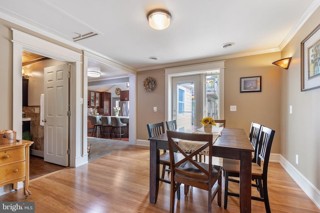 1104 N Pleasantview Rd, Pottstown, PA 19464 - dining space featuring light wood-style floors, ornamental molding, and baseboards