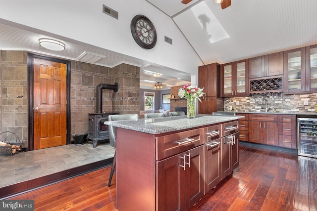 1104 N Pleasantview Rd, Pottstown, PA 19464 - kitchen with dark wood finished floors, glass insert cabinets, light stone countertops, a kitchen island, and high vaulted ceiling