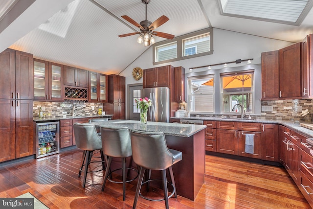 1104 N Pleasantview Rd, Pottstown, PA 19464 - kitchen featuring stainless steel appliances, wine cooler, a sink, a kitchen breakfast bar, and tasteful backsplash
