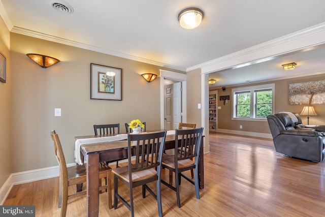 1104 N Pleasantview Rd, Pottstown, PA 19464 - dining space with ornamental molding, light wood finished floors, and baseboards