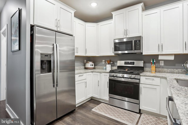 117 King St Unit A, Bensalem, PA 19020 - kitchen featuring appliances with stainless steel finishes, dark wood-style floors, white cabinetry, light stone countertops, and recessed lighting