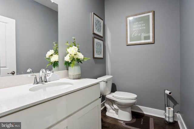 117 King St Unit A, Bensalem, PA 19020 - half bathroom with toilet, vanity, wood finished floors, and baseboards