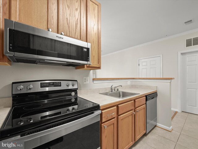 2608 Chapel Lake Dr Unit 112, Gambrills, MD 21054 - kitchen featuring appliances with stainless steel finishes, a sink, ornamental molding, light tile patterned flooring, and light countertops