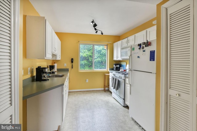 4212 Benning Rd NE Unit 5, Washington, DC 20019 - kitchen featuring white appliances, white cabinets, rail lighting, and built in desk