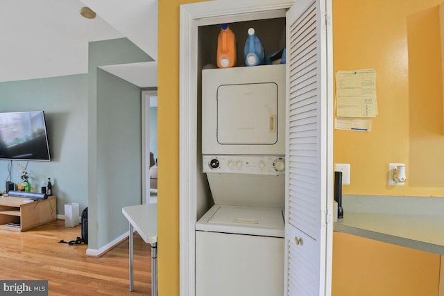 4212 Benning Rd NE Unit 5, Washington, DC 20019 - washroom with stacked washer and clothes dryer and light wood-type flooring