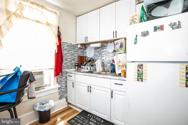 616 Chestnut Ave, Trenton, NJ 08611 - kitchen featuring freestanding refrigerator, a sink, white cabinets, tasteful backsplash, and light wood-style floors
