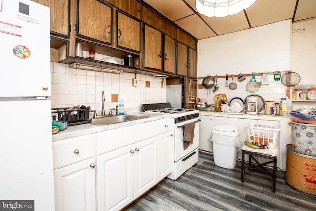 616 Chestnut Ave, Trenton, NJ 08611 - kitchen with white appliances, backsplash, a sink, light countertops, and dark wood-style flooring
