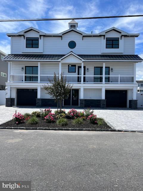 11 Selma Dr, Manahawkin, NJ 08050 - view of front of house with a standing seam roof, metal roof, and a garage
