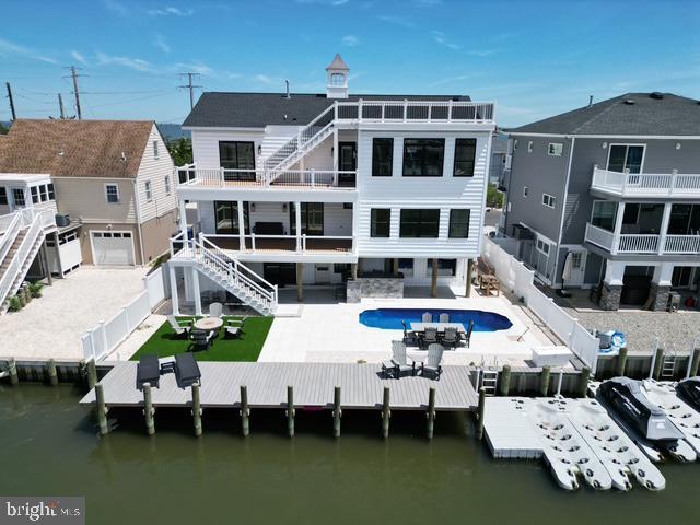 11 Selma Dr, Manahawkin, NJ 08050 - rear view of property with stairs, a fenced backyard, and a water view