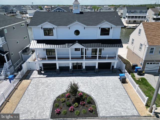 11 Selma Dr, Manahawkin, NJ 08050 - view of front of property with decorative driveway, an attached garage, and a residential view
