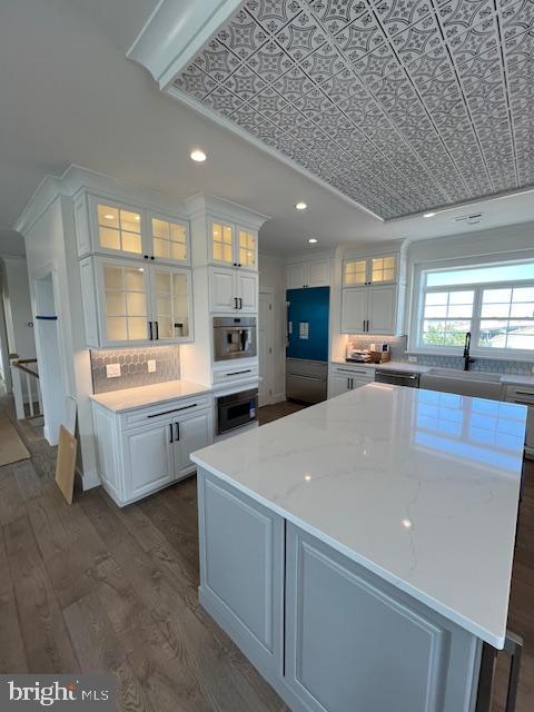 11 Selma Dr, Manahawkin, NJ 08050 - kitchen with a sink, white cabinets, dark wood-type flooring, an ornate ceiling, and a center island