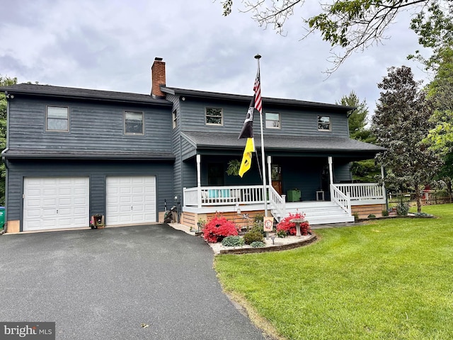 207 Lee Ave, Galena, MD 21635 - view of front of property with covered porch, a front yard, a chimney, driveway, and an attached garage