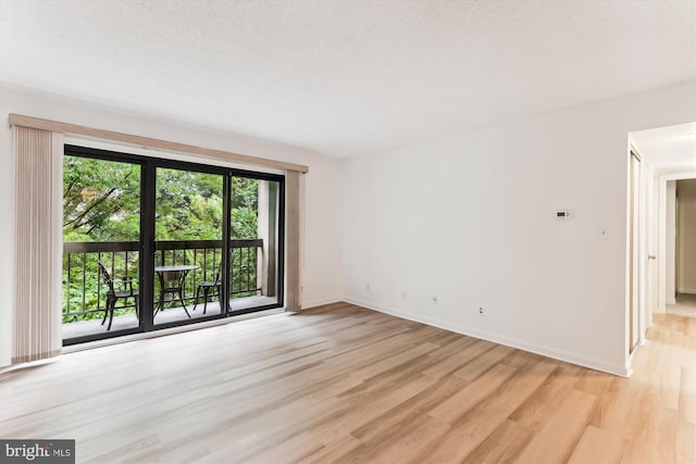 801 N Howard St Unit 305, Alexandria, VA 22304 - spare room featuring light wood-style flooring and baseboards