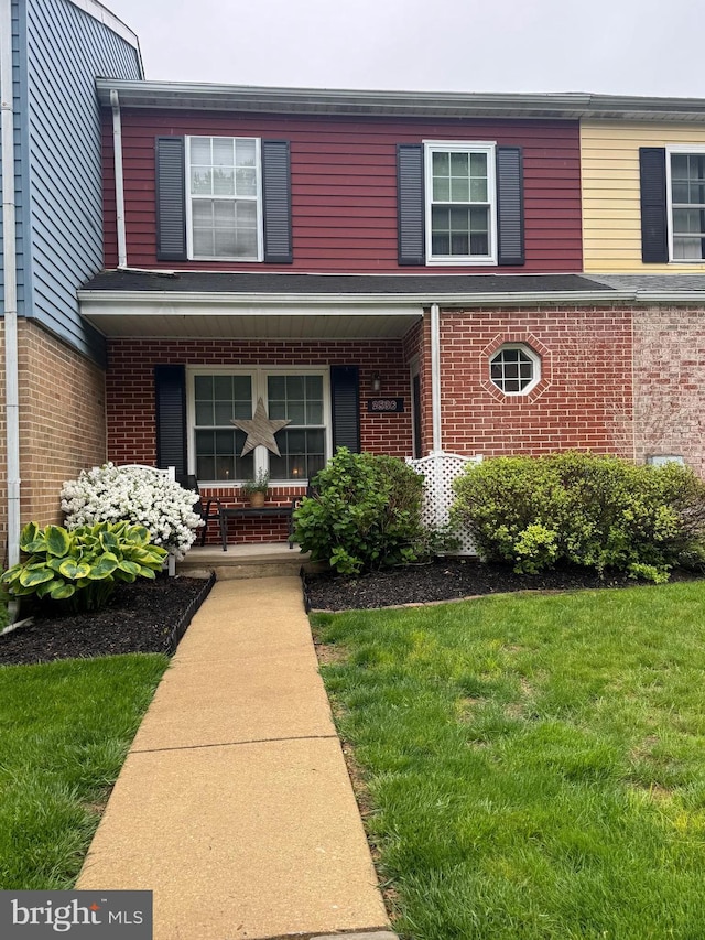 2536 Dupont St, Coatesville, PA 19320 - view of front of property featuring covered porch, brick siding, and a front yard
