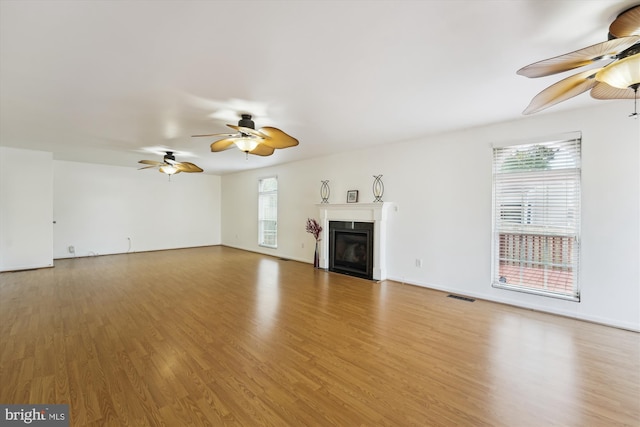6775 Amherst Rd, Bryans Road, MD 20616 - unfurnished living room with ceiling fan, wood finished floors, a fireplace with flush hearth, and baseboards