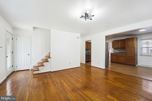 6775 Amherst Rd, Bryans Road, MD 20616 - unfurnished living room featuring stairway, dark wood-style floors, a chandelier, and baseboards