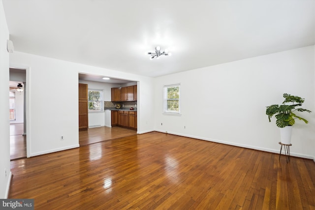 6775 Amherst Rd, Bryans Road, MD 20616 - unfurnished living room featuring baseboards and dark wood-type flooring