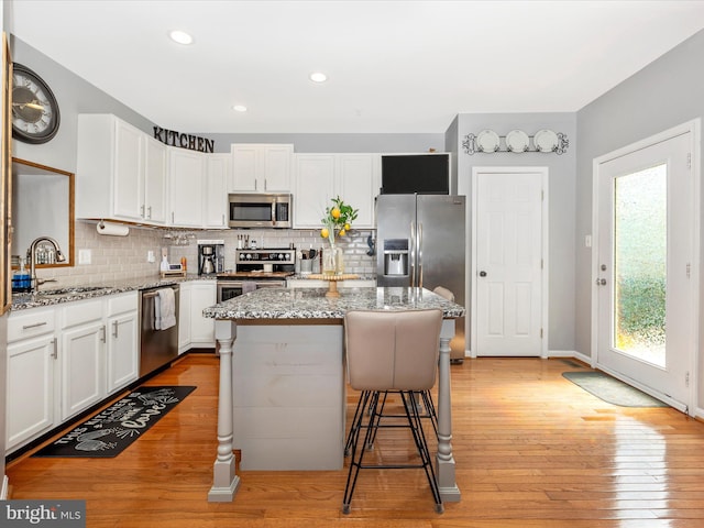 1501 Rambling Way, Frederick, MD 21701 - kitchen featuring appliances with stainless steel finishes, white cabinetry, decorative backsplash, light stone countertops, and recessed lighting