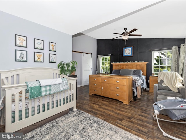 1501 Rambling Way, Frederick, MD 21701 - bedroom featuring a barn door, wood finished floors, a decorative wall, a ceiling fan, and lofted ceiling