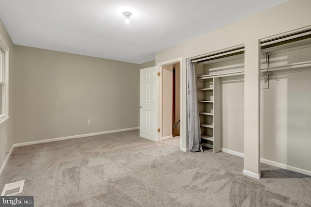 8760 Stoneridge Dr, Manassas, VA 20111 - unfurnished bedroom with multiple closets, carpet floors, and baseboards