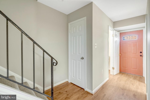 8760 Stoneridge Dr, Manassas, VA 20111 - entryway with light wood finished floors, baseboards, and stairs