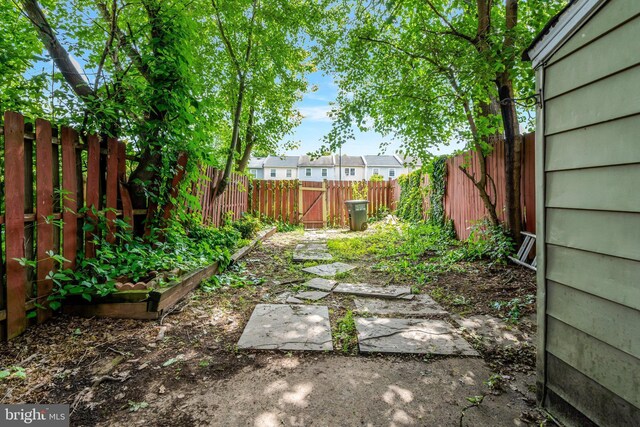8760 Stoneridge Dr, Manassas, VA 20111 - fenced backyard featuring a vegetable garden