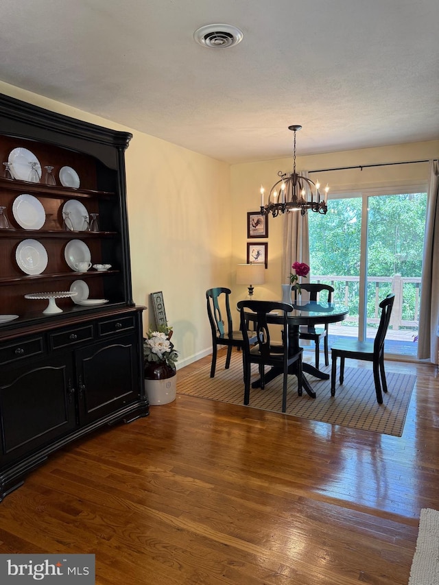 55 Ithica Ln, High View, WV 26808 - dining area with baseboards, a chandelier, and dark wood-type flooring