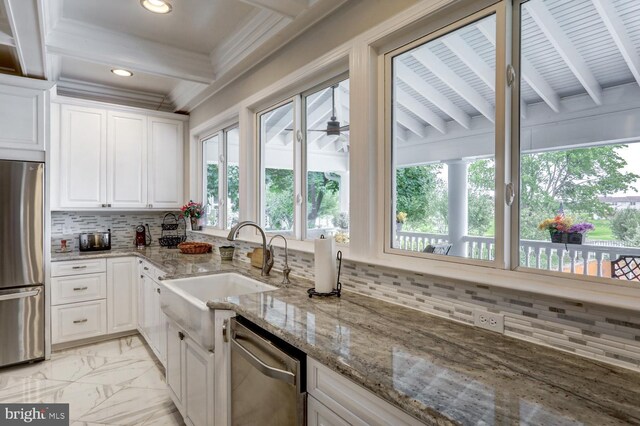 419 Coffee Goss Rd, Marietta, PA 17547 - kitchen featuring appliances with stainless steel finishes, beam ceiling, a sink, white cabinetry, and backsplash