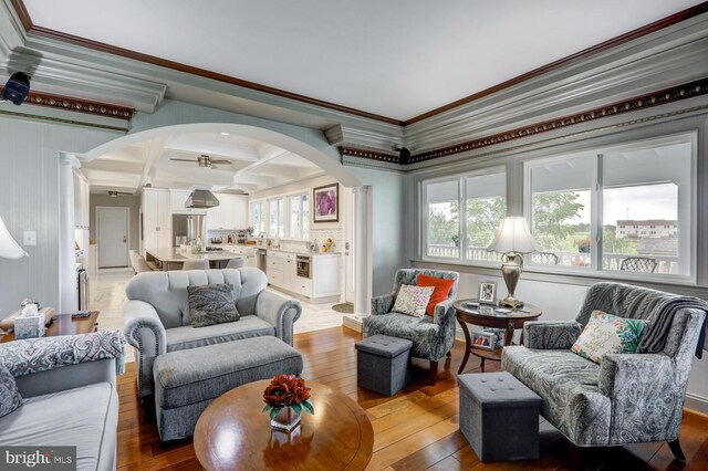 419 Coffee Goss Rd, Marietta, PA 17547 - living area with arched walkways, decorative columns, light wood finished floors, ornamental molding, and coffered ceiling
