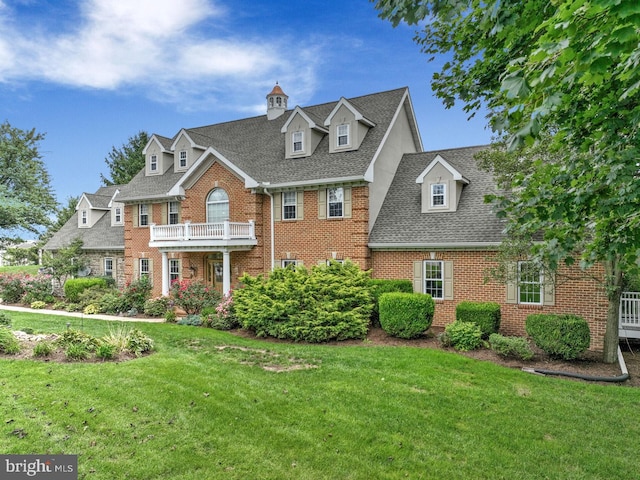 419 Coffee Goss Rd, Marietta, PA 17547 - colonial home featuring brick siding, a front lawn, and a shingled roof