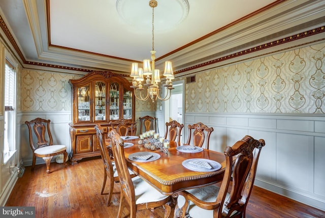 419 Coffee Goss Rd, Marietta, PA 17547 - dining space featuring a chandelier, wallpapered walls, a decorative wall, crown molding, and wood finished floors