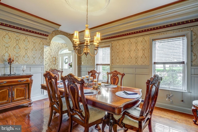 419 Coffee Goss Rd, Marietta, PA 17547 - dining area with wallpapered walls, a decorative wall, wood finished floors, a chandelier, and arched walkways