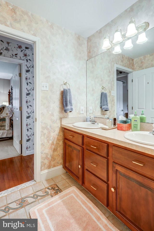 419 Coffee Goss Rd, Marietta, PA 17547 - bathroom with double vanity, tile patterned flooring, wallpapered walls, ensuite bathroom, and baseboards