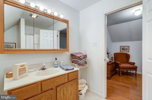 419 Coffee Goss Rd, Marietta, PA 17547 - bathroom with vaulted ceiling, vanity, wood finished floors, and baseboards