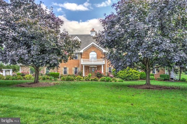 419 Coffee Goss Rd, Marietta, PA 17547 - colonial house with brick siding, a front yard, and a chimney