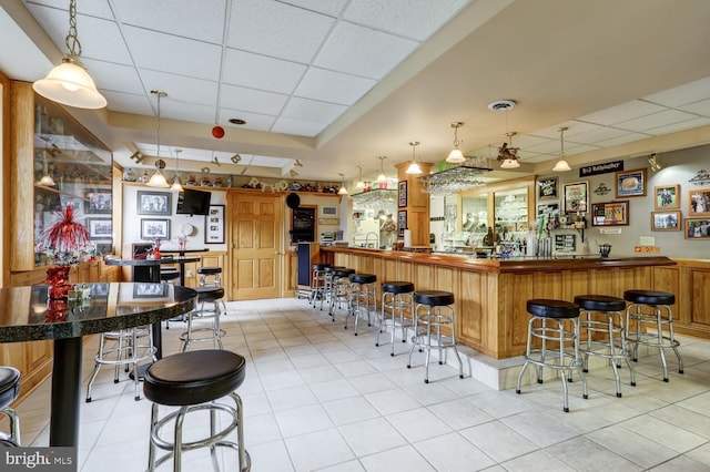 419 Coffee Goss Rd, Marietta, PA 17547 - indoor wet bar with a paneled ceiling, light tile patterned flooring, and hanging light fixtures