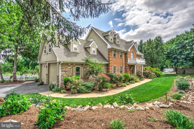 419 Coffee Goss Rd, Marietta, PA 17547 - view of front of house with a balcony, stone siding, a garage, driveway, and roof with shingles