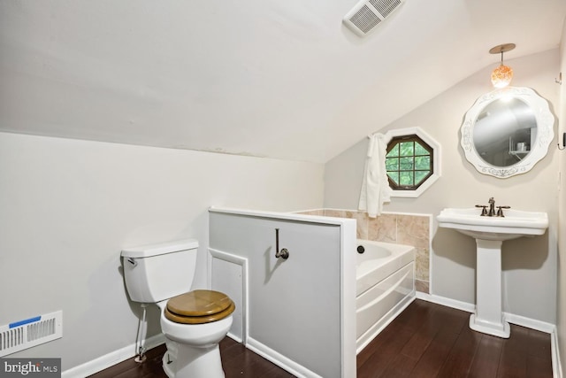 810 Sugarland Run Dr, Sterling, VA 20164 - bathroom with wood finished floors, a garden tub, toilet, vaulted ceiling, and baseboards