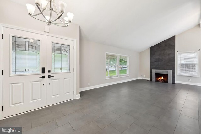 810 Sugarland Run Dr, Sterling, VA 20164 - foyer entrance featuring a chandelier, vaulted ceiling, a fireplace, dark tile patterned flooring, and baseboards