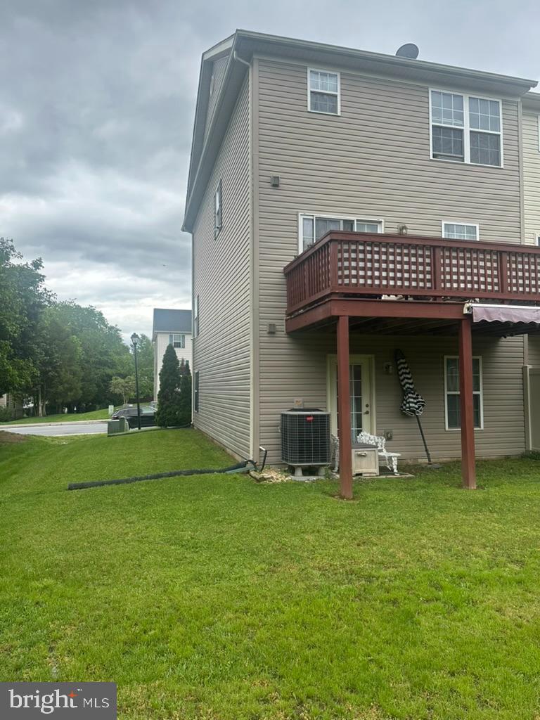 224 Morlatt Ln, Martinsburg, WV 25404 - rear view of house featuring central air condition unit, a lawn, and a wooden deck