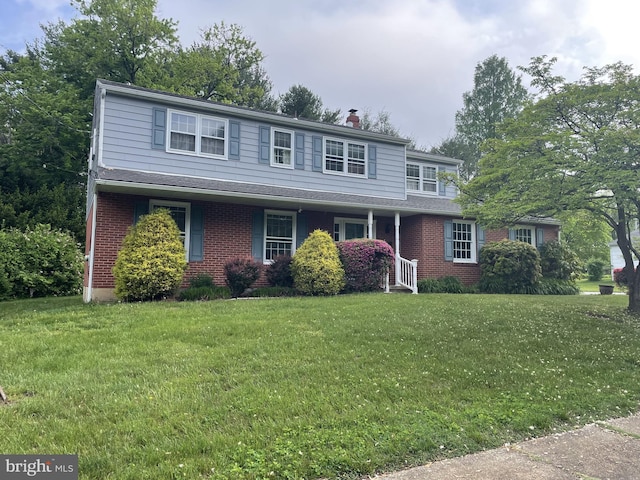 202 Wilshire Ln, Newark, DE 19711 - traditional home featuring a front lawn, brick siding, and a chimney
