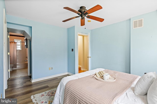 31 S Ann St, Baltimore, MD 21231 - bedroom with arched walkways, wood finished floors, baseboards, ensuite bath, and ceiling fan