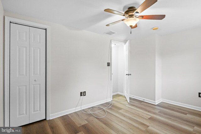 31 S Ann St, Baltimore, MD 21231 - unfurnished bedroom featuring wood finished floors, baseboards, ceiling fan, and a closet