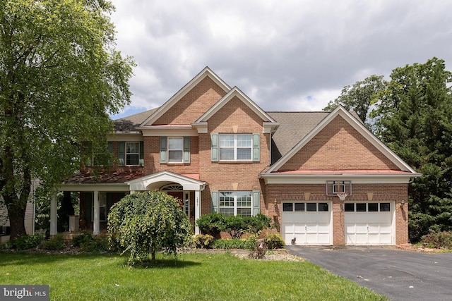 1877 Clayton Ridge Dr, Winchester, VA 22601 - view of front of home featuring brick siding, an attached garage, driveway, and a front yard