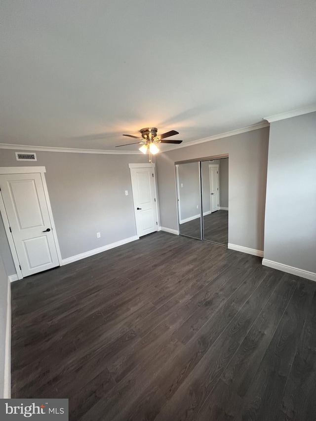 1712 W 65th Ave, Philadelphia, PA 19126 - unfurnished bedroom featuring baseboards, ornamental molding, dark wood-style flooring, a ceiling fan, and a closet