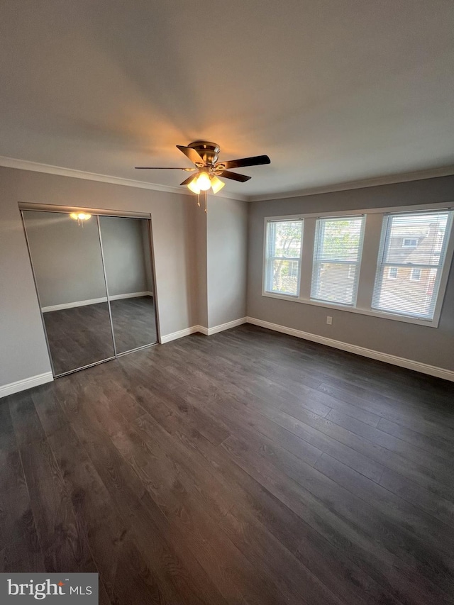 1712 W 65th Ave, Philadelphia, PA 19126 - unfurnished bedroom with crown molding, dark wood-style flooring, and baseboards